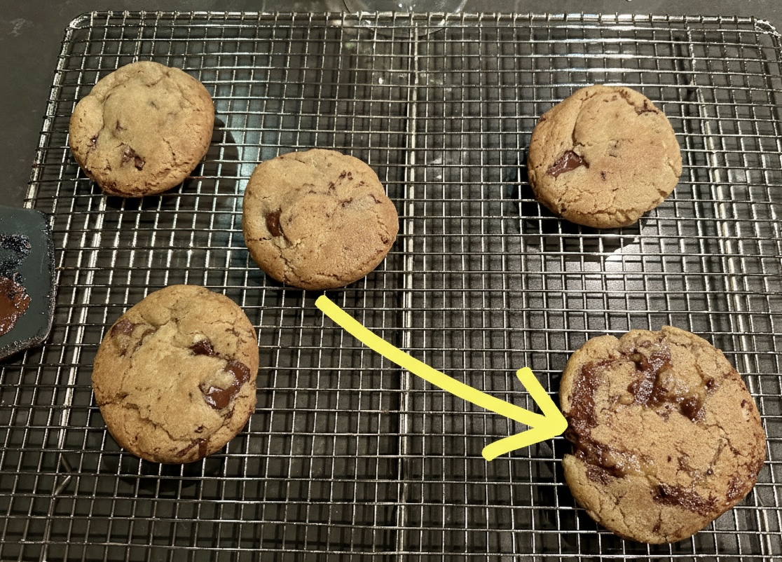 Close-up of a freshly baked smashed chocolate-chip cookie with a crinkled surface